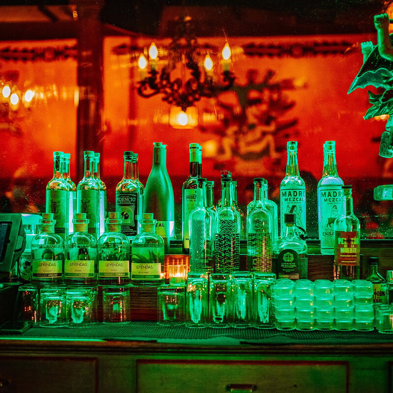 Back of the bar with a mirror in the back.